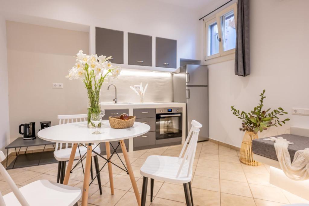 a kitchen and dining room with a table and chairs at Little Yard Studios & Apartments #4 in Naxos Chora
