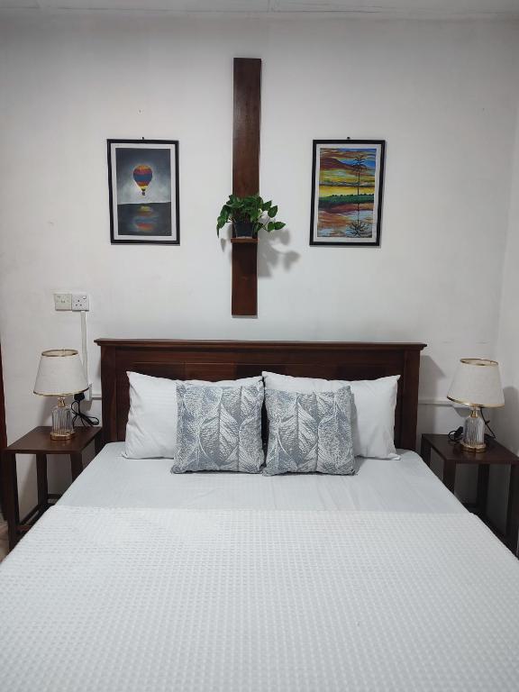 a bedroom with a large bed with two lamps at Hatton Easy Stay in Hatton