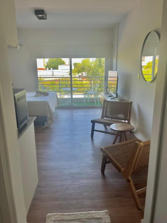a room with a bed and a couch and a tv at L&J Loft 1 ambiente in Belén de Escobar