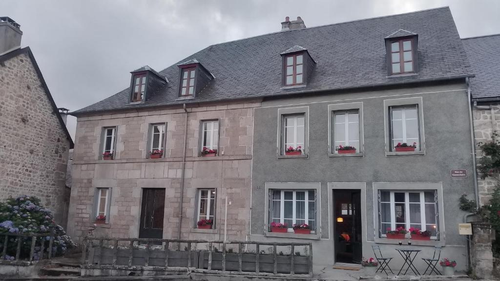 a gray house with windows and a gray roof at Monsieur Morgan's in Féniers