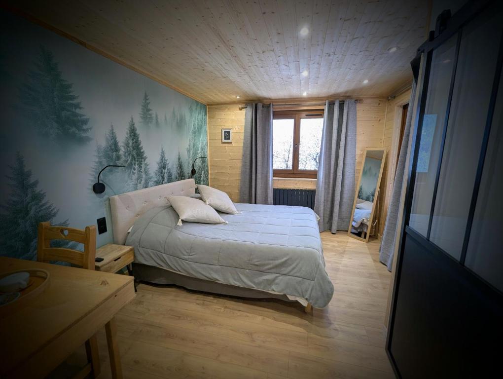 a bedroom with a bed and a painting on the wall at Auberge Saint Antoine in Pelvoux