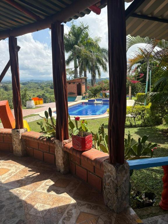 a patio with a view of a swimming pool at Rancho Akila in Filandia