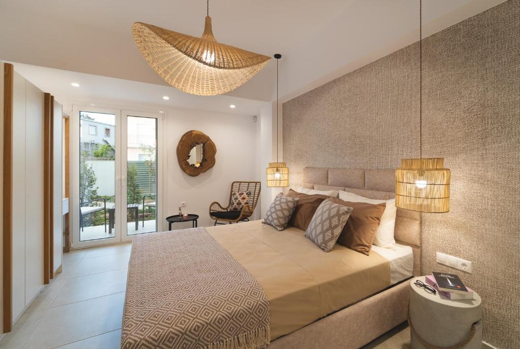 a bedroom with a large bed and a large window at Anemone House in Mesokhórion