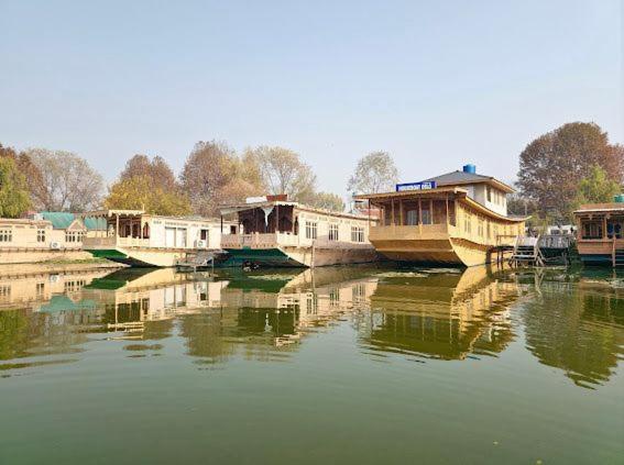 a group of boats sitting in the water at Cheetah Palace in Srinagar