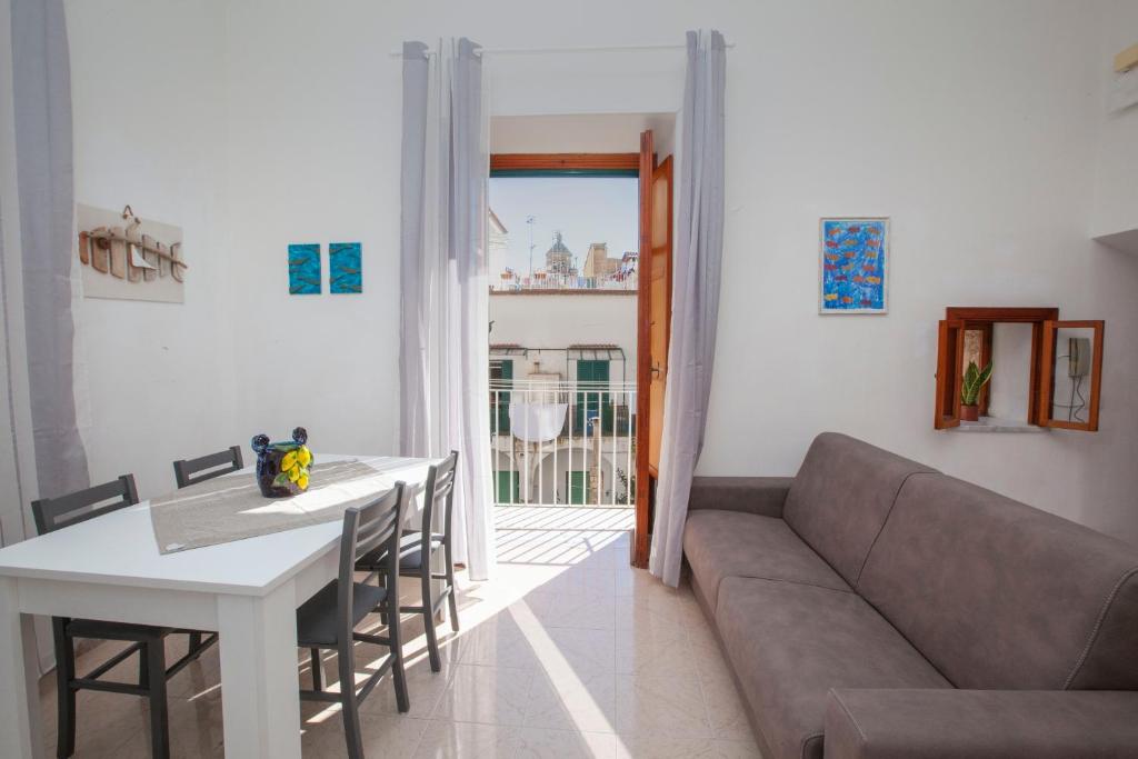 a living room with a couch and a table at Amalfi mia - city center in Amalfi