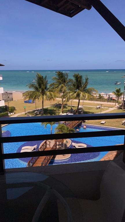 a view of the beach from the balcony of a resort at Maui Beach Residence, 3 quartos, Tamandaré PE in Tamandaré