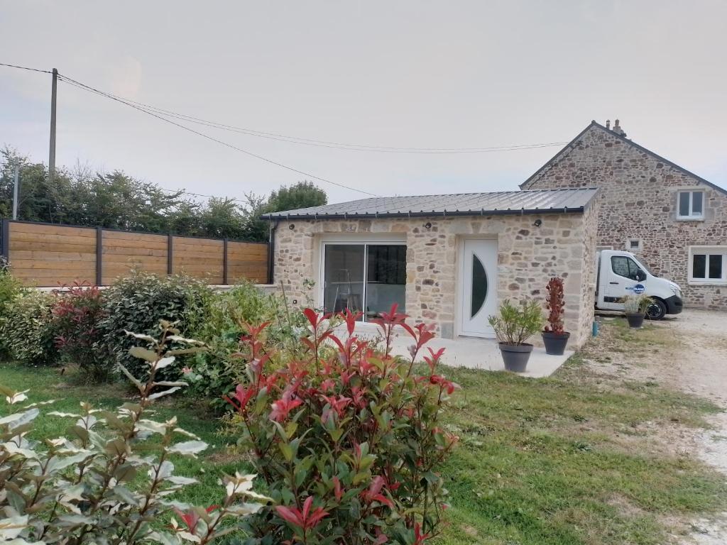 a stone house with a garden at Chez Mat's & Lou in Rocheville