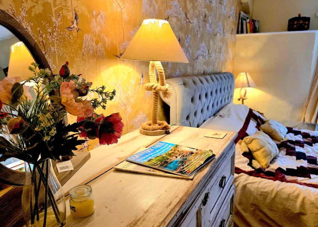 a bedroom with a desk with a lamp and a bed at The Annexe Lurley Manor in Tiverton