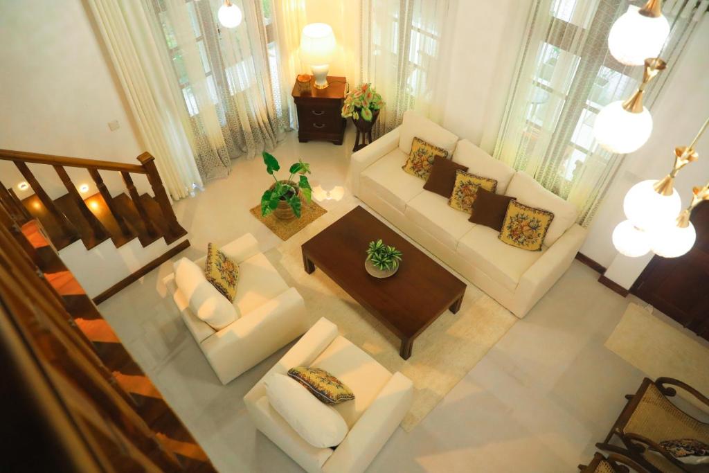 an overhead view of a living room with couches and a table at Cinnamon River Retreat in Magammana