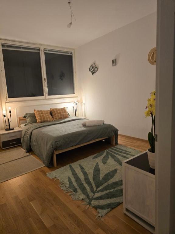a bedroom with a bed and a large window at welcome geneva in Geneva