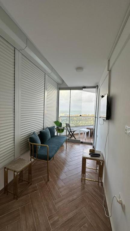a living room with a blue couch and a table at Sheraton Palace Sea View in Alexandria