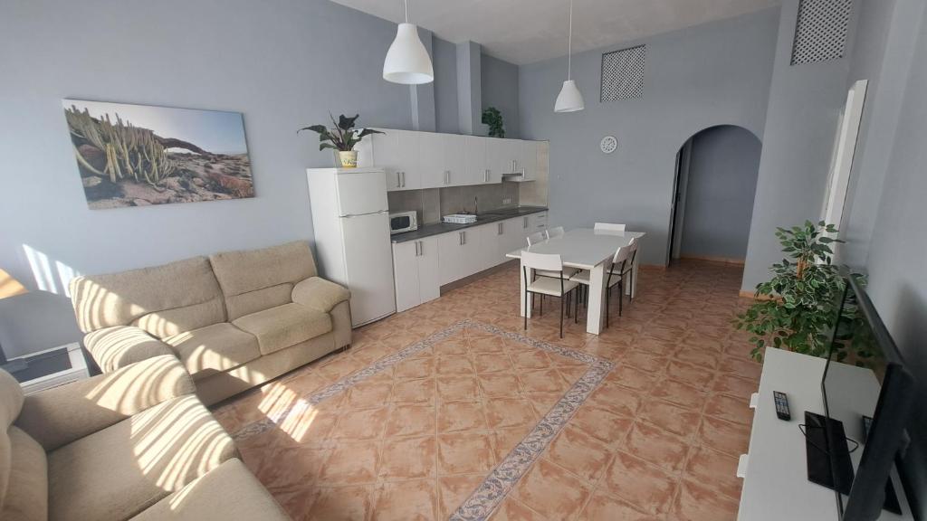 a living room with a couch and a table at Casa Naihu in La Listada