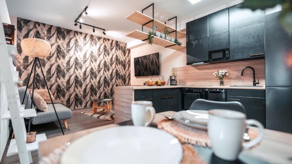 a kitchen with black cabinets and a table at FlexHome Gemütliche Ferienwohnung in Lippstadt