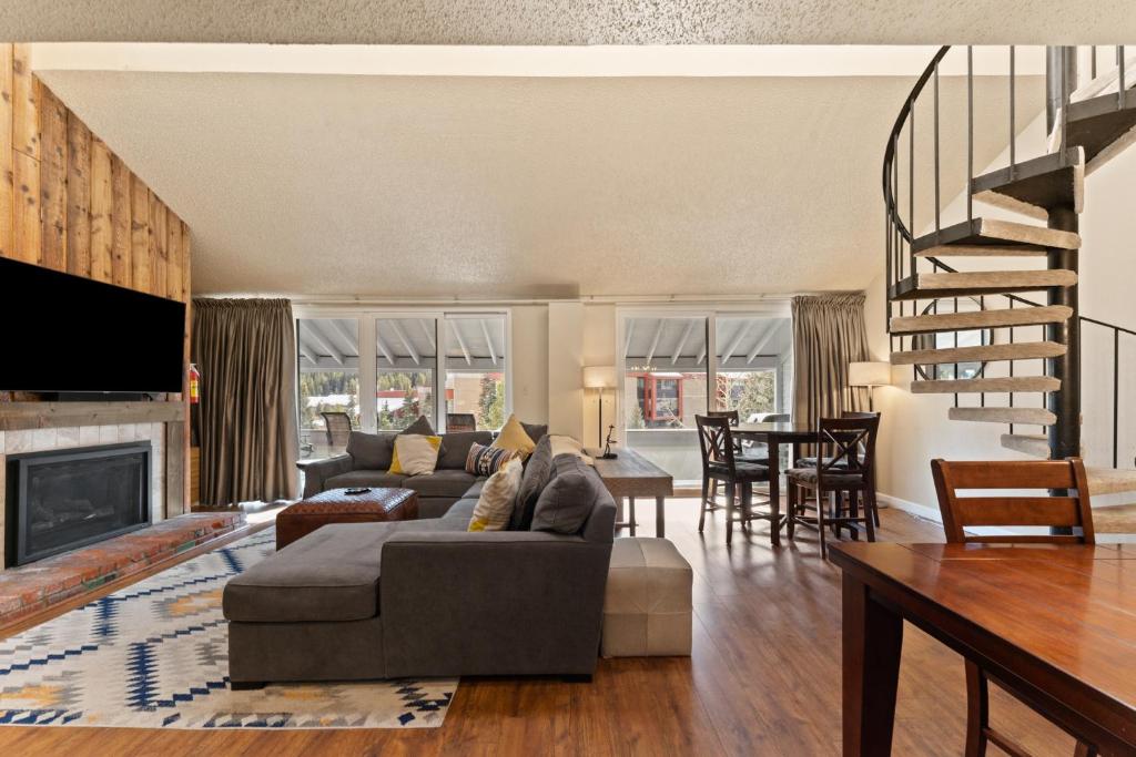a living room with a couch and a fireplace at Snowbridge Square #F206 in Copper Mountain