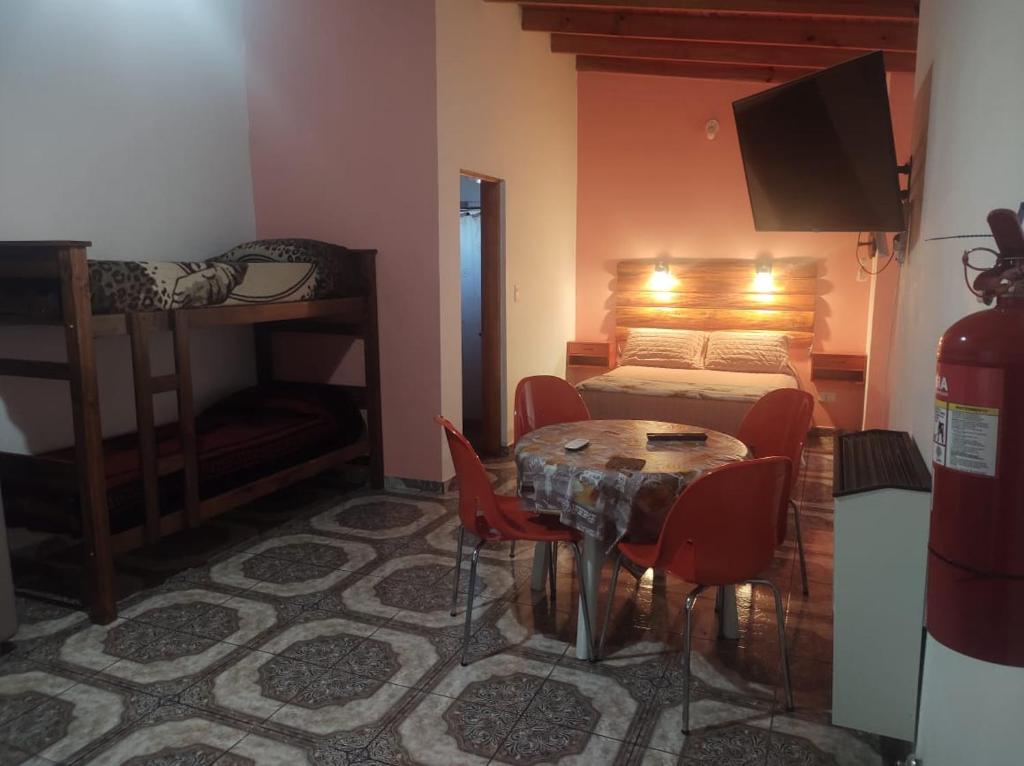 a bedroom with a bed and a table and chairs at Las Tres Reinas B in Colorado River