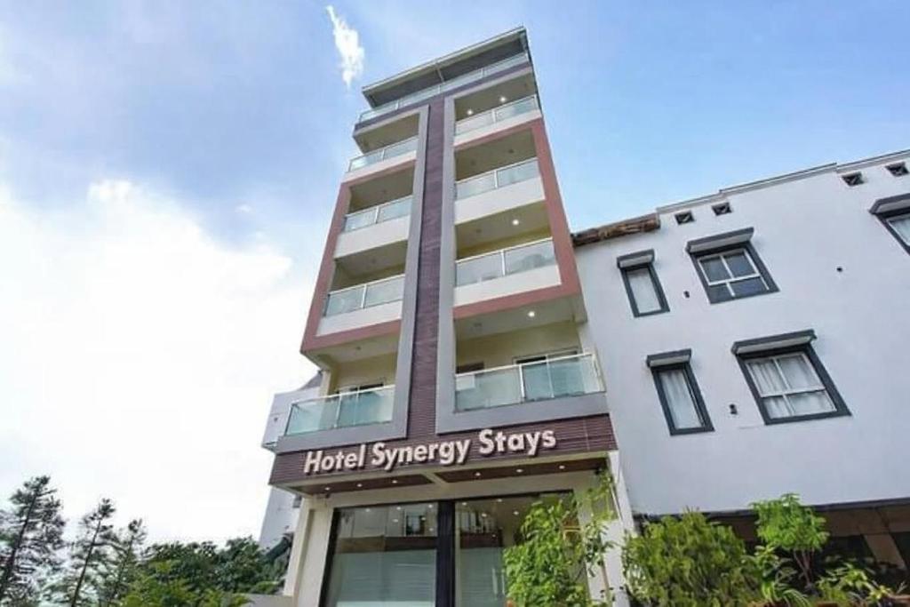 a building with a hotel synergy stays sign on it at Hotel Synergy Stays in Indore