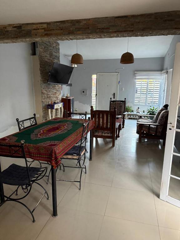 a dining room and living room with a table and chairs at Casa Susana in Jesús María
