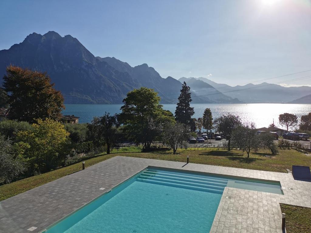a swimming pool with a view of a lake and mountains at Marion's Apartment in Riva di Solto
