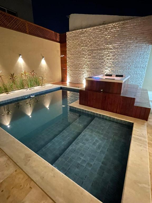 a swimming pool with a tub in a house at Pipa Sunset Mansion in Pipa