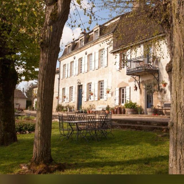 a bench in front of a large building at La Montagne in Tournus