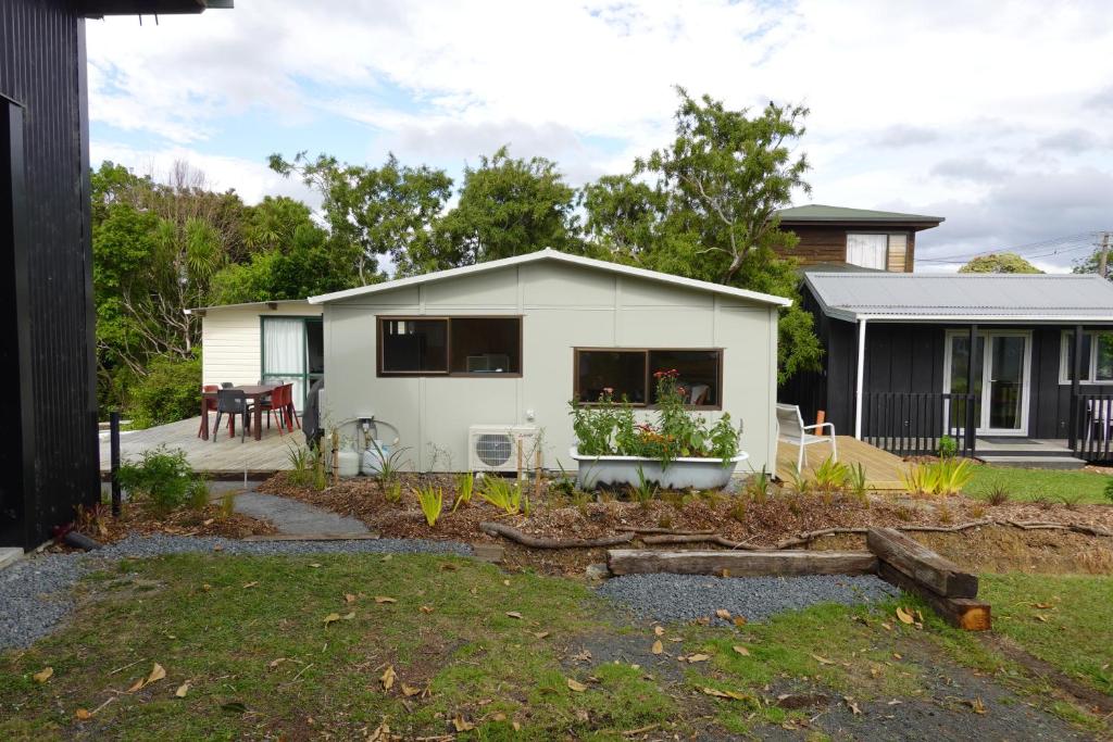 a house with a garden in front of it at One Pigeon Takatu in Tawharanui