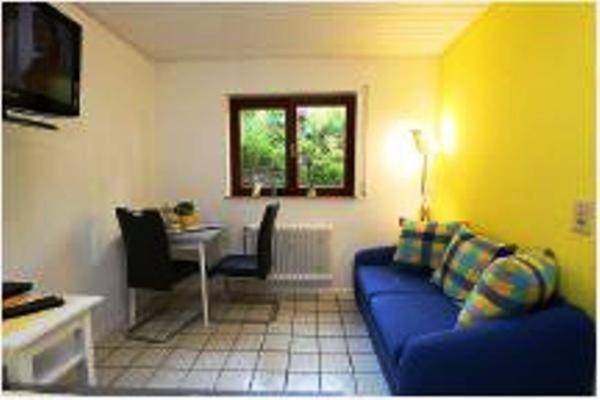 a living room with a blue couch and a table at wohnung-nr-2 in Kirchzarten