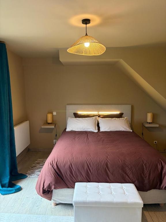 a bedroom with a large bed with a purple blanket at Jardin des prés in Le Thil-en-Vexin