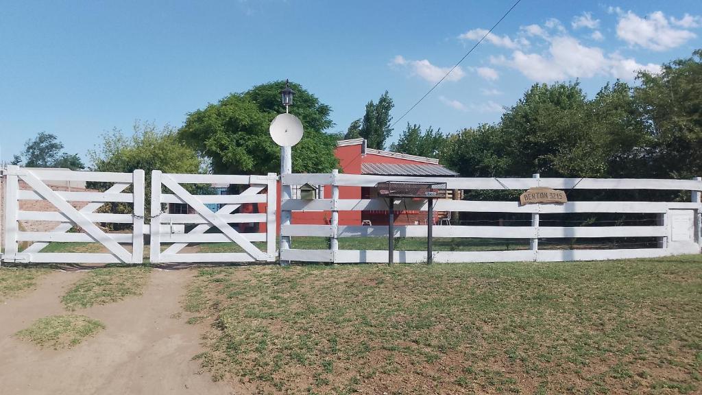 a white fence in front of a house at En Santa Rosa in Santa Rosa