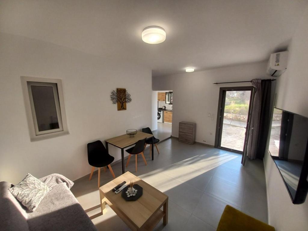 a living room with a couch and a table at Velania House 1 in Filótion