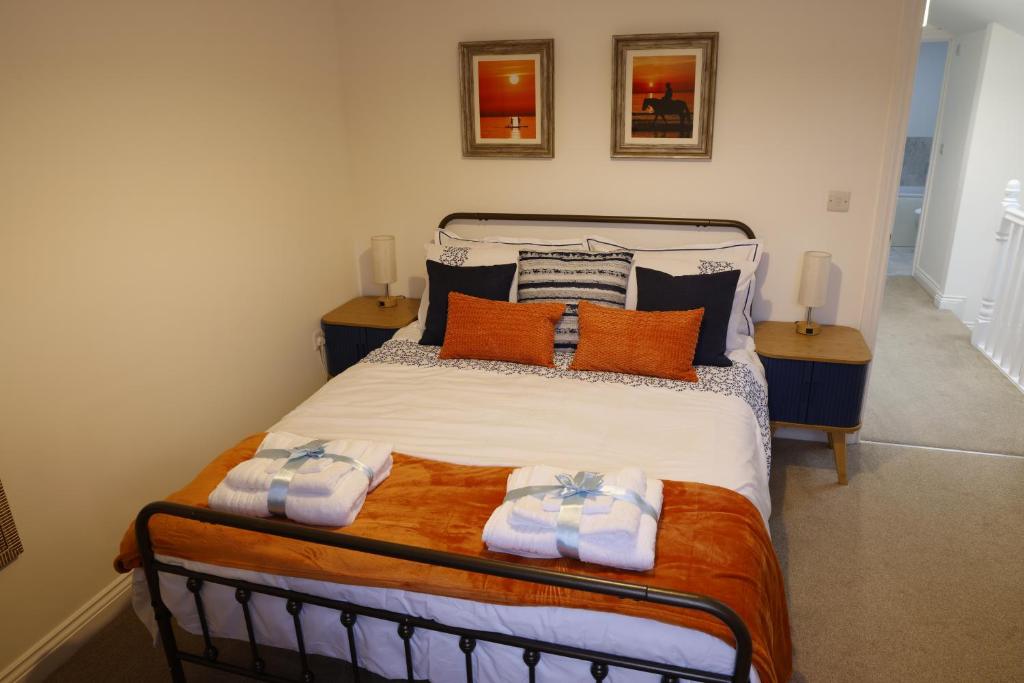 a bedroom with a bed with towels on it at Converted Coastal Coach House in Weston-super-Mare