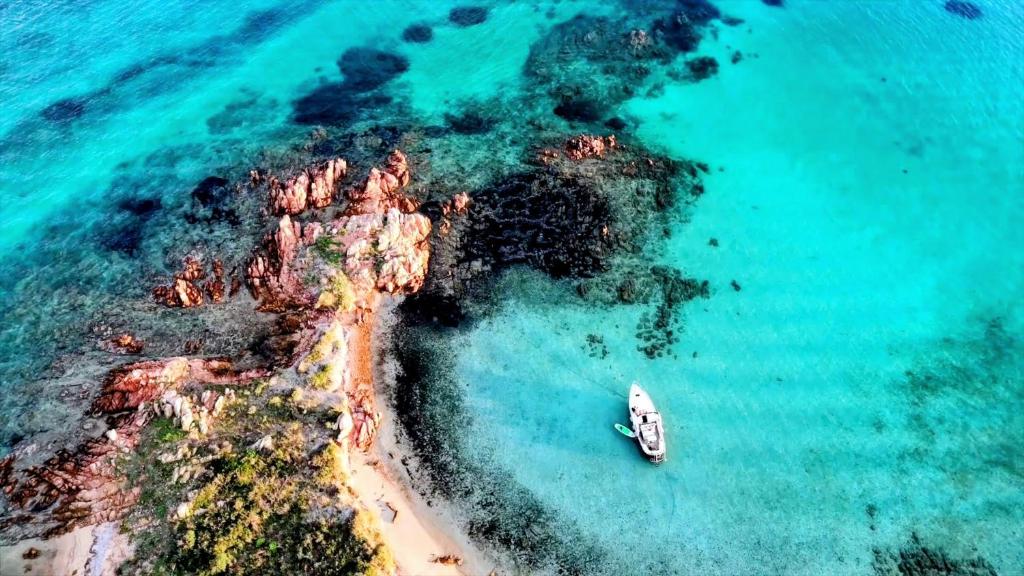 an aerial view of a boat in the ocean at Sleeping on a boat in the Island's bay in Porto San Paolo