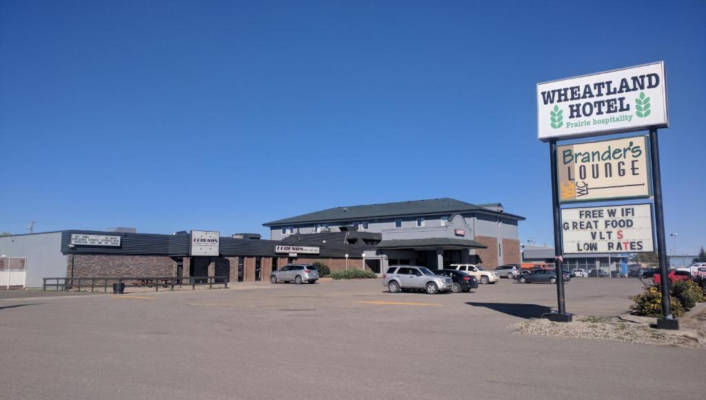 a parking lot in front of a shopping center at Wheatland Hotel in Strathmore