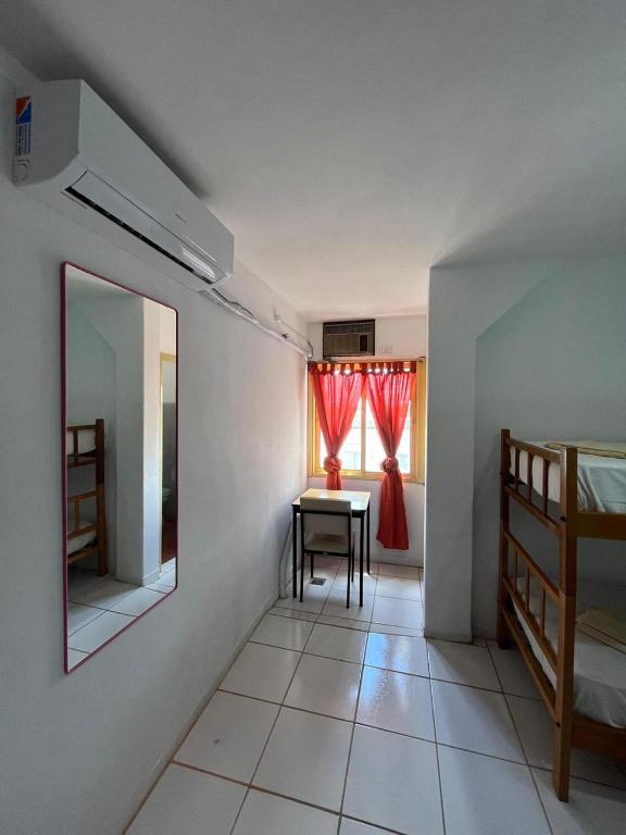 a room with a mirror and a table and a bed at Hospedaje Buen Descanso in Paso de los Libres