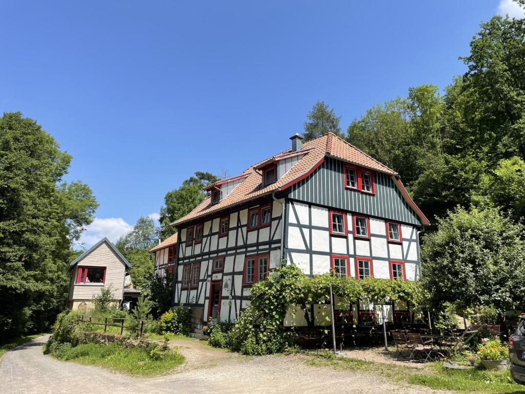 a large white and black building with red windows at Kaffeemühle Hamma I in Heringen