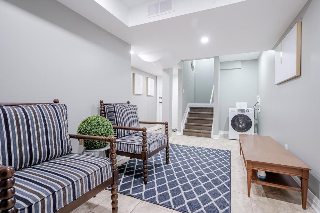 a living room with two chairs and a table at Bright Modern 1BR Suite Free Parking Fast WiFi Self Check-In in Bowmanville