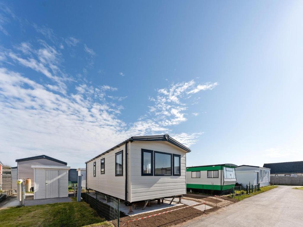 a tiny house sitting on top of a yard at Comfortable mobile home in Middelkerke in Middelkerke