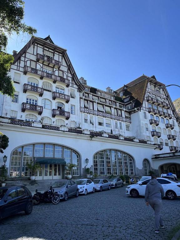 a large white building with cars parked in front of it at Palácio Quitandinha in Petrópolis