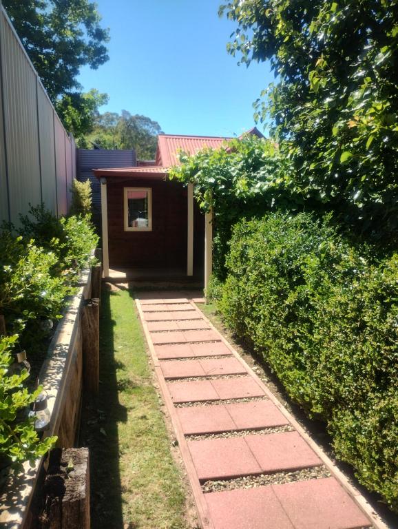 a garden path leading to a house at Bella Rouge Cottage in Bright