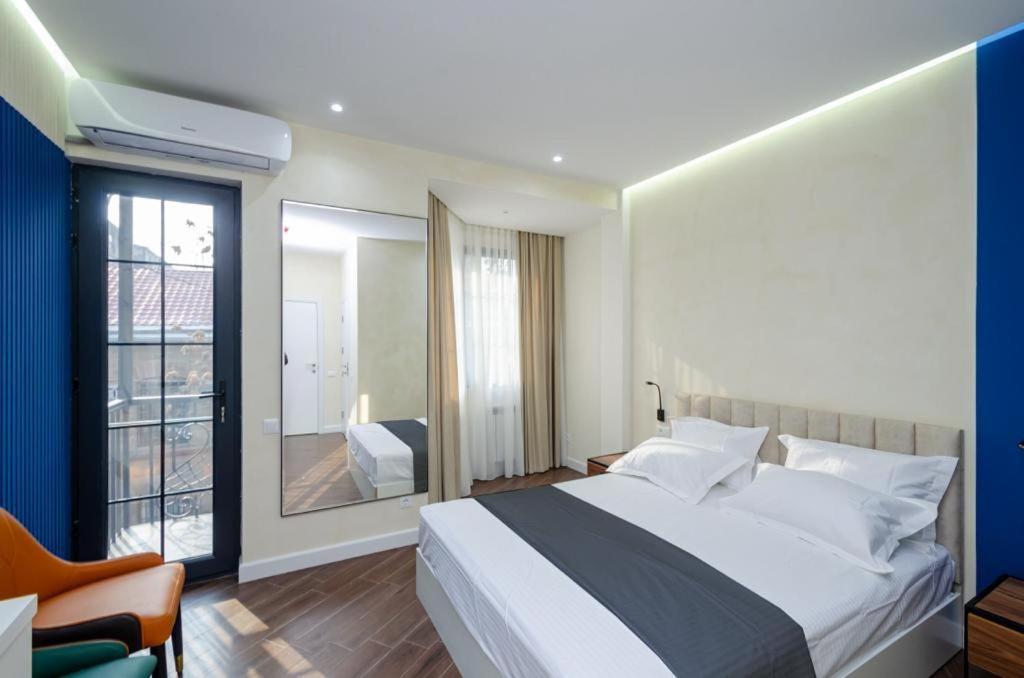 a bedroom with a large bed and a window at Mashtots Avenue 31 in Yerevan