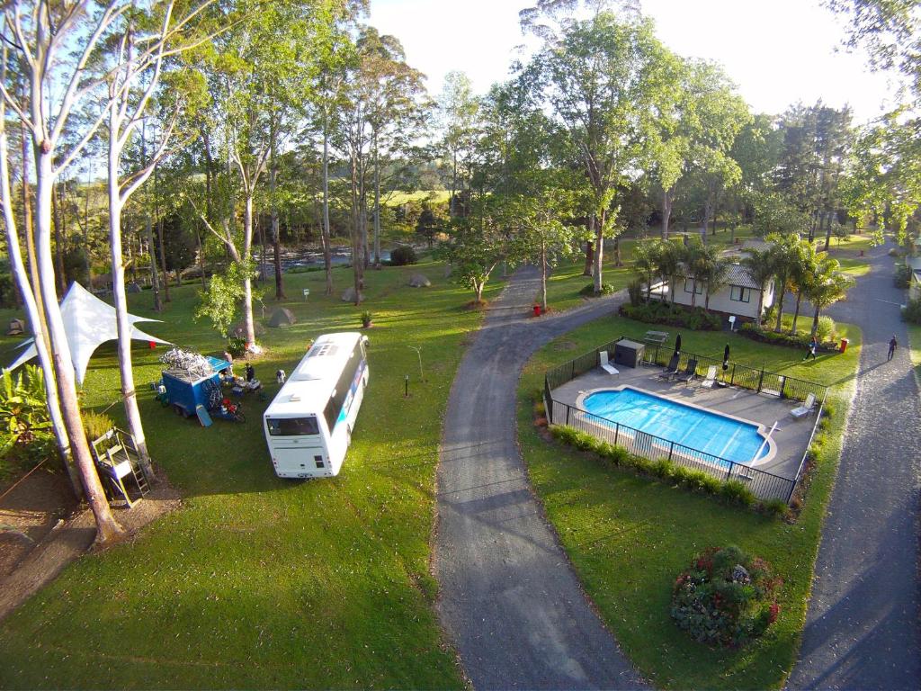 an rv parked in a yard next to a pool at Bay of Islands Holiday Park in Paihia