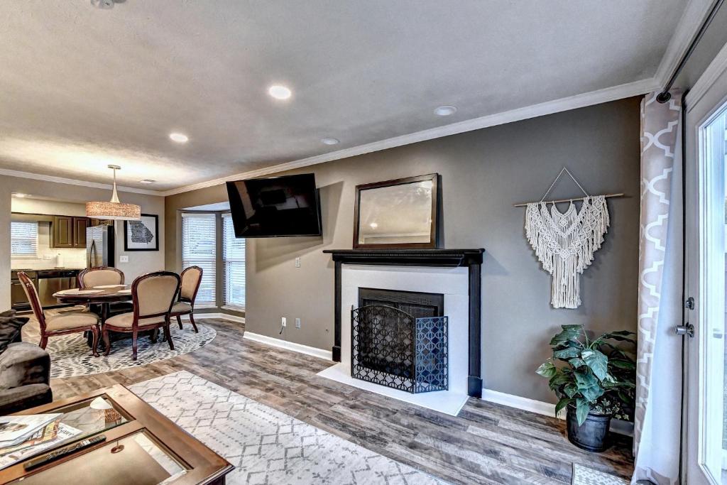 a living room with a fireplace and a dining room at Alpharetta Dreaming in Alpharetta