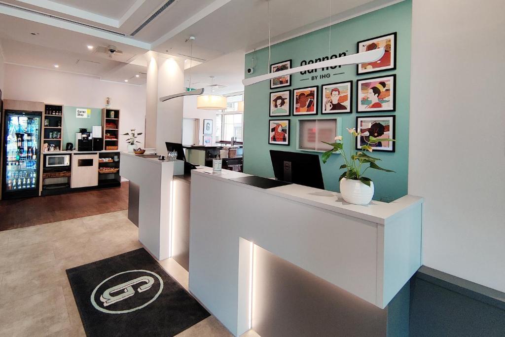 a lobby of a pharmacy with a reception counter at Garner Hotel Wiesbaden City by IHG in Wiesbaden