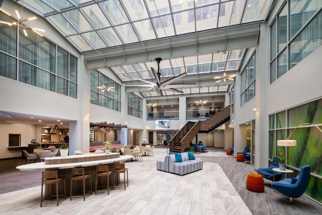 an office lobby with a glass ceiling and furniture at EVEN Hotel Pittsburgh Downtown by IHG in Pittsburgh