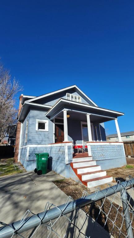 a blue house with a green trash can in front of it at Historic Reno Home in Reno