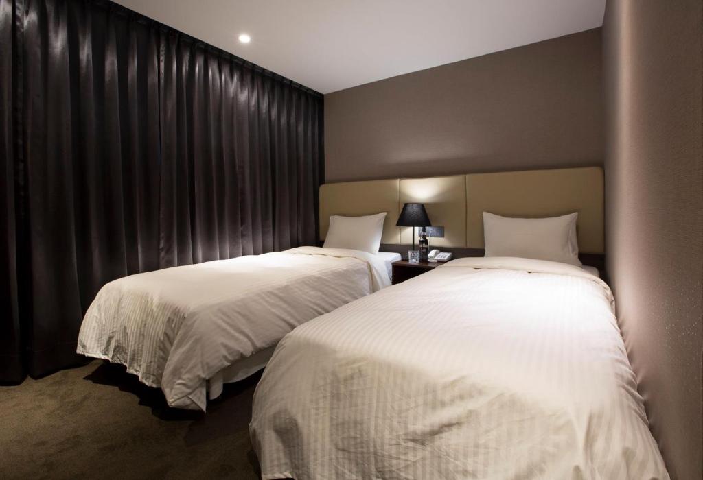 Postel nebo postele na pokoji v ubytování Noble Hotel