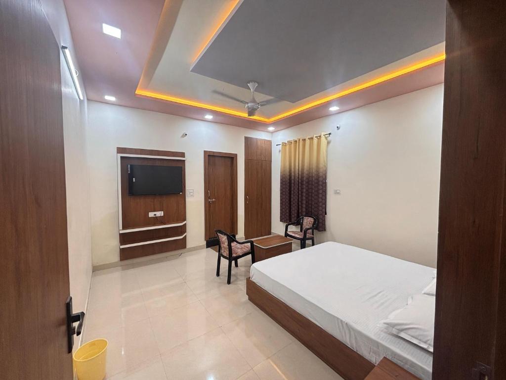 a hotel room with a bed and a tv at Hotel KK palace in Chittaurgarh