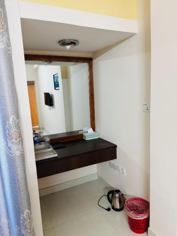 a bathroom with a sink and a mirror at Hotel Sarbick International in Kukrāil