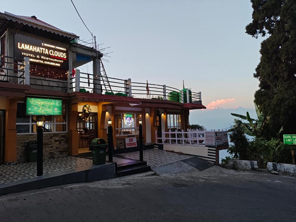 a building with a sign in front of it at Lamahatta Clouds Hotel & Restaurant in Takdāh