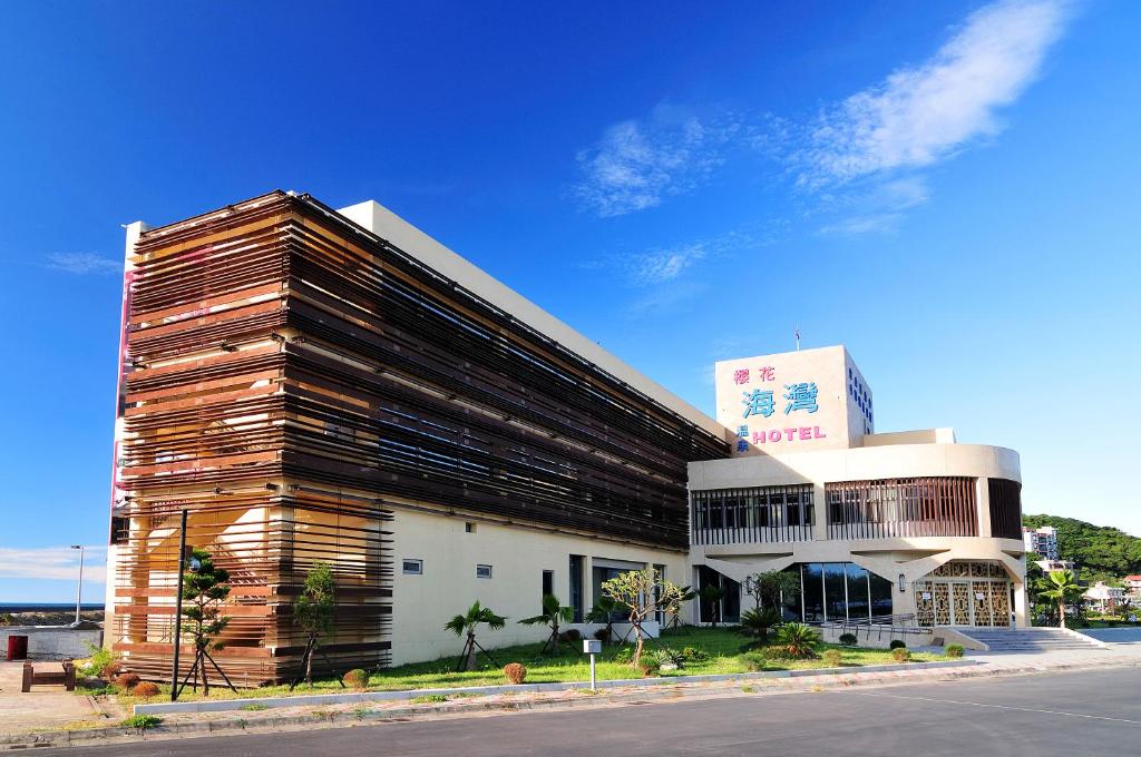 a large wooden building on the side of a street at JinShan Sakura Bay Hot Spring Hotel in Jinshan