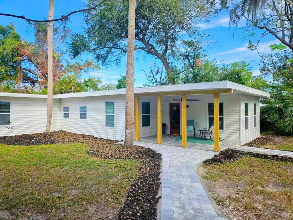 a white house with yellow columns at Heavenly Hideaway in Daytona Beach